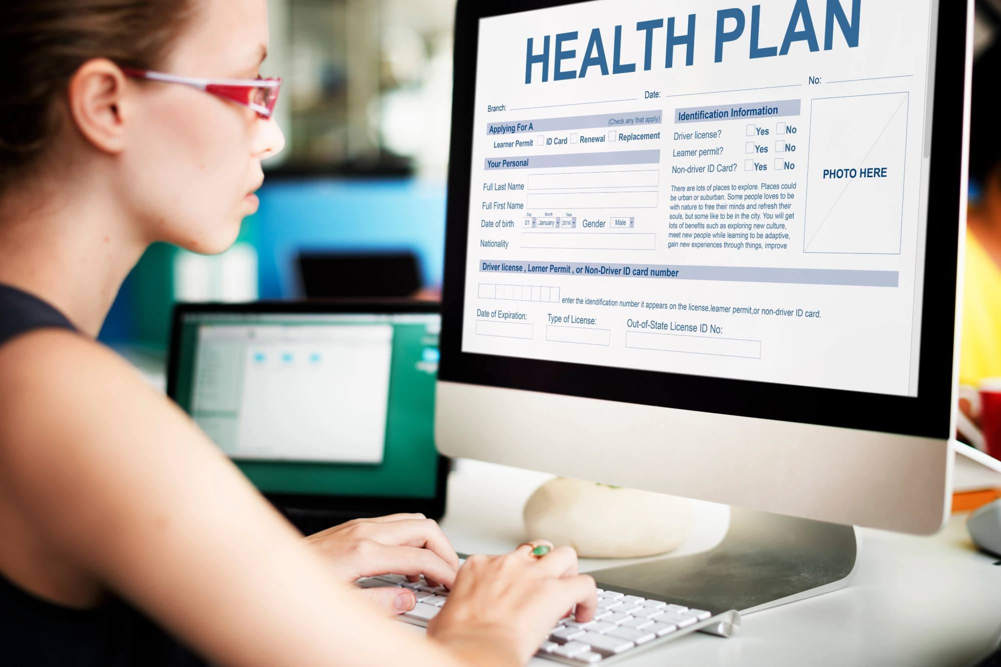 an image of a person filling out insurance forms on a computer